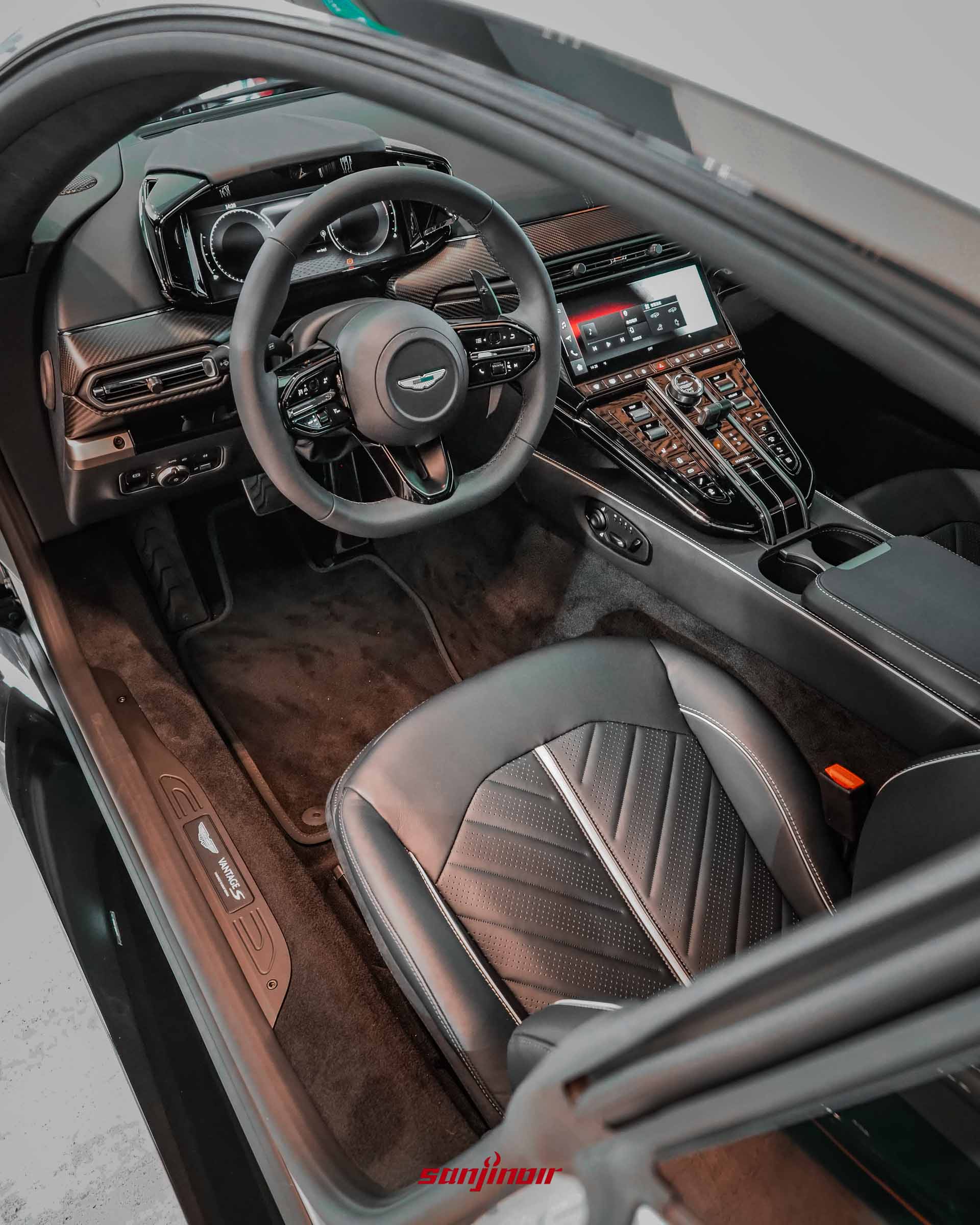 豪華跑車駕駛座艙視角，包含皮革座椅、中控台與方向盤