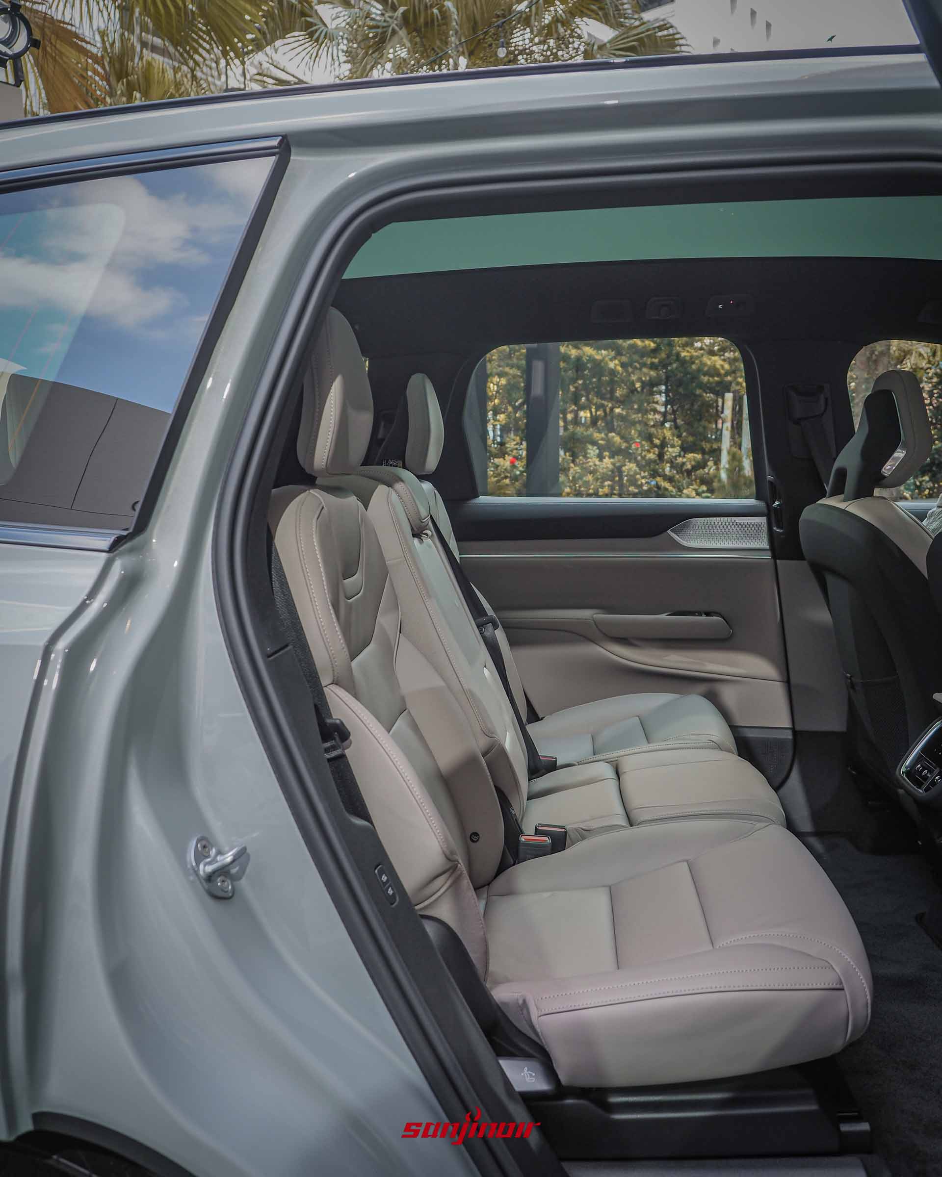 從開啟的右後車門看向Volvo EX90的第二排淺米色座椅,車頂配有全景玻璃天窗,地板相當平整無隆起。