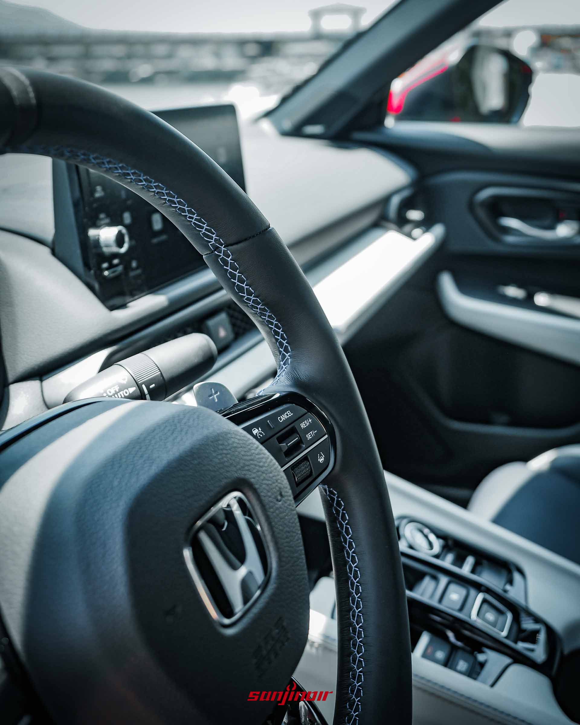 特寫HONDA Prelude方向盤左側與後方的金屬換檔撥片,方向盤皮質邊緣帶有精緻的藍色交叉縫線。