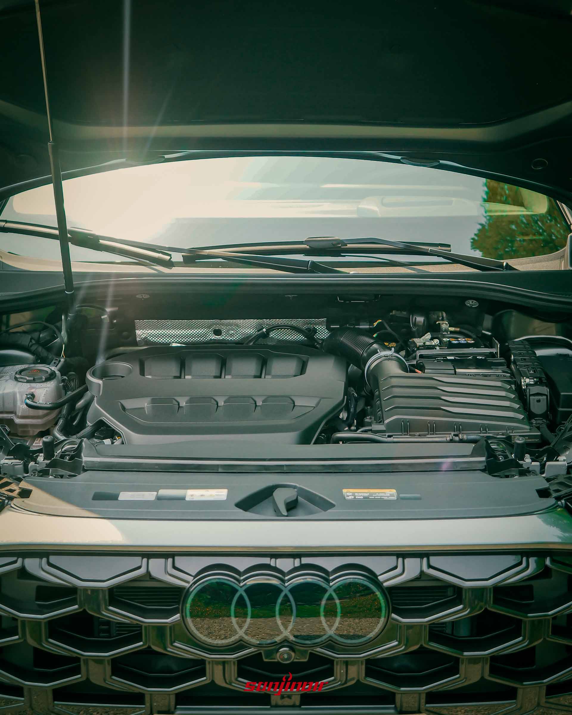 Audi Q3引擎蓋開啟，展示內部的2.0L TFSI引擎室配置。